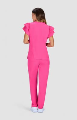A pink outfit featuring a top with ruffled sleeves and matching trousers, set against a grey background.