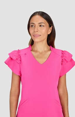 A dress in bright pink featuring ruffled shoulders and a V-neckline, displayed on a model against a neutral background.