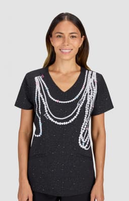 A black top with a speckled pattern featuring faux pearl embellishments arranged in a decorative design.