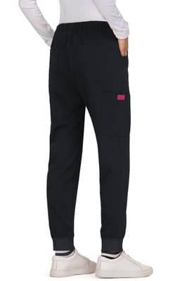 Black Aster Pants with an elastic waistband and a single pocket, styled with fitted cuffs and worn with white shoes.