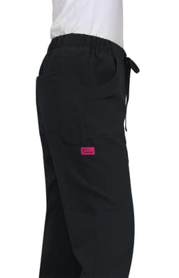 A pair of black Aster Pants featuring pockets and an elastic waist, with a pink branding label.