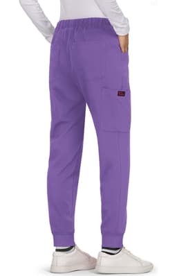 A pair of purple Aster Pants featuring side pockets and cuffed ankles, worn with white shoes.