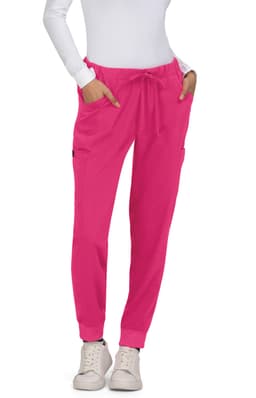 Bright pink Aster Pants with pockets, worn by a model in a white top and casual shoes.