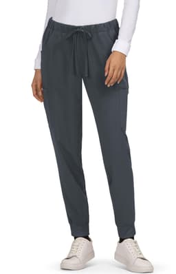 A pair of dark grey Aster Pants with adjustable drawstring and side pockets, worn with white sneakers.