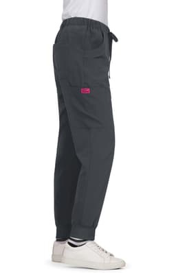 A pair of grey Aster Pants featuring an elastic waistband and a side pocket, displayed from the side.