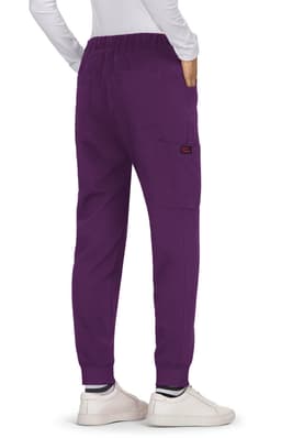 A pair of purple Aster Pants with an elastic waistband and side pockets, worn with white shoes.