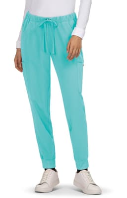 Turquoise jogger pants with a drawstring waist and side pockets, paired with white sneakers.
