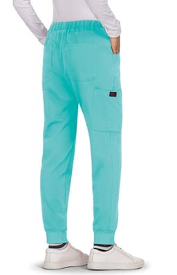 A pair of turquoise pants with a relaxed fit, featuring pockets and worn with white shoes.