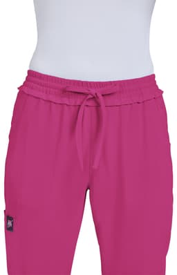A pair of bright pink pants with an elastic waistband and drawstring, featuring a small logo.