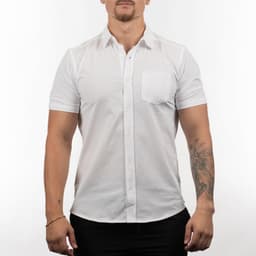 A short sleeve shirt in white, featuring a front pocket and a logo on the chest area.