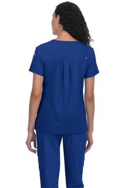 A blue medical scrub top with a relaxed fit, featuring a pleat detail at the back and a logo on one sleeve.