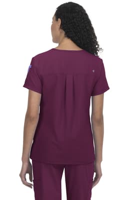 A jersey top in burgundy, featuring a pleated back design and short sleeves. It has a logo on the sleeve.