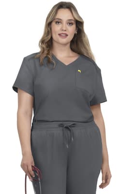 A woman wearing grey scrubs with a pocket and a yellow logo, holding a stethoscope.