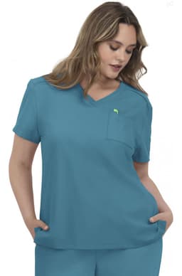 A woman wearing a teal scrubs top with a v-neck and a chest pocket. The top has a logo on it.