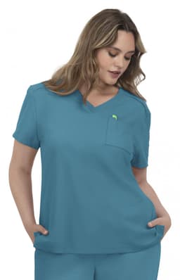 A scrubs top in a teal blue colour with a pocket and a logo on the chest.
