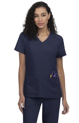 A navy blue scrub top featuring a V-neck design and a pocket with scissors. The model has curly hair.