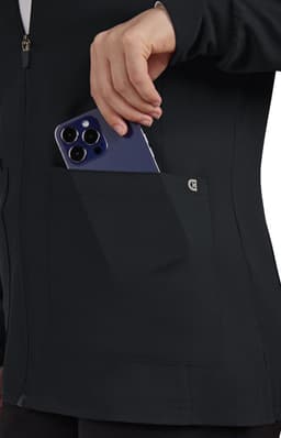 A black women's jacket featuring a side pocket with a smartphone being placed inside. It has a branding logo.
