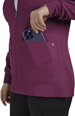 A women's jacket in maroon with a zip front and pocket, featuring a smartphone being placed inside.