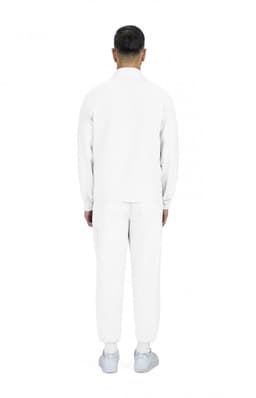 A man wearing a white jacket and matching pants, viewed from the back. The outfit features a simple design.