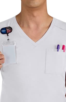 A white V-neck shirt with two pockets, one containing pens and a name badge holder.