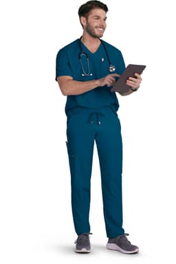 A man wearing teal scrubs and a stethoscope, holding a tablet and smiling.