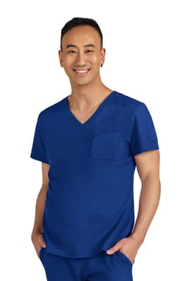 A blue medical scrub top with a V-neck and a chest pocket, worn by a smiling individual.