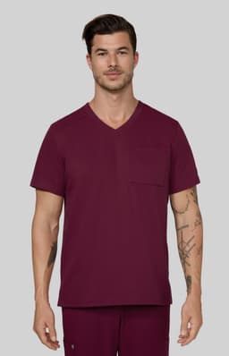 A scrub top in a rich burgundy colour, featuring a V-neck design and a chest pocket, worn by a male model.