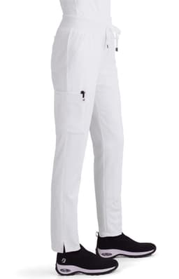 White cargo pants featuring side pockets and a drawstring waist, paired with black shoes. The image includes branding.