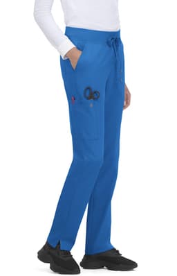 Atria Pant in blue, featuring pockets and a drawstring waist, displayed on a model wearing a white top and shoes.