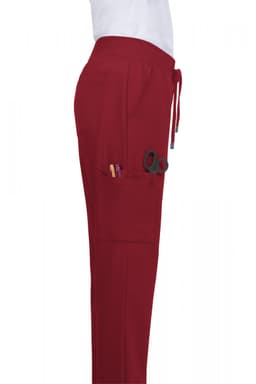 Atria Pant in burgundy, featuring multiple pockets and a drawstring waist, shown from the side.