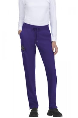 Atria Pant in purple featuring a drawstring waist and side pockets, displayed on a model wearing a white top.