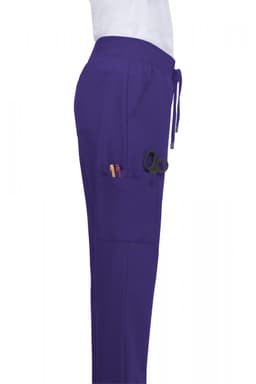 Atria Pant in purple, featuring side pockets and a drawstring waistband. The product includes a logo on the waistband.