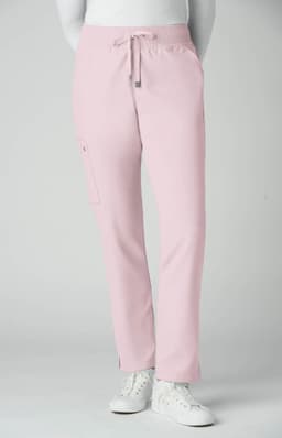 Atria Pant in soft pink, featuring a drawstring and side pocket, modelled by a person wearing white sneakers.