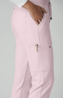 A pink pant featuring a pocket detail and a side pen holder, designed for utility and comfort.