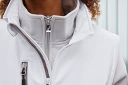 A softshell work vest in light grey, featuring a high collar and zippered pockets, with a logo displayed.
