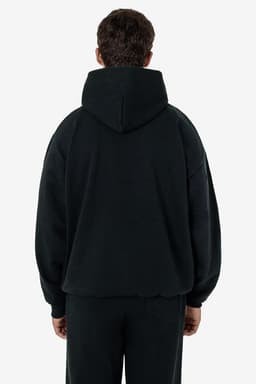 A heavy fleece hood pullover in black, featuring a relaxed fit and a hood at the back. The model is seen from behind.