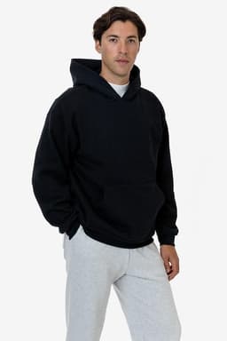 A heavy fleece hood pullover in navy blue, worn by a model, featuring a front pocket and a hood.