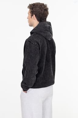 A heavy fleece hooded pullover in mineral wash grey, featuring a hood and casual fit. It has branding on it.