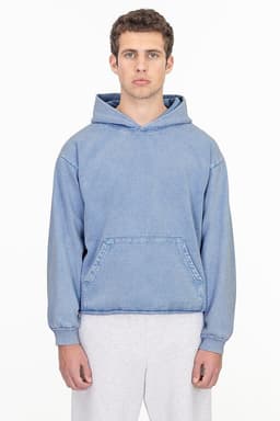 A blue mineral wash hooded pullover with a front pocket and a logo, worn by a model.