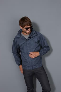 A men's outer jacket in navy, featuring a hood, worn by a model with sunglasses, set against a grey background.