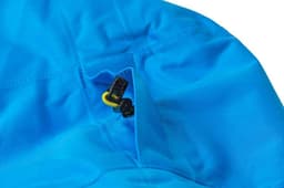 A bright blue outdoor jacket featuring a zippered pocket and toggles on the hood. It includes a logo.