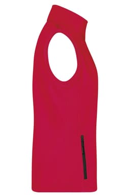 A red ladies softshell vest featuring a sleeveless design and a side zip pocket. It has a logo on it.