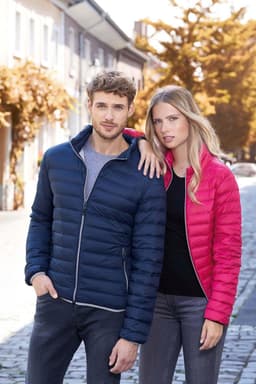 A navy blue and a pink puffer jacket displayed on two models in an outdoor setting. Both jackets have zippers and a logo.