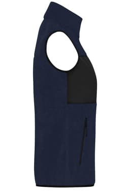 A navy ladies fleece vest featuring a black front panel and a zip pocket. Includes a small logo on the chest.