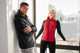 A red Ladies Hybrid Jacket with black sleeves is displayed on a model, alongside a black jacket on another model.