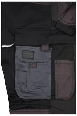Close-up of black workwear stretch-pants featuring grey pockets and a branded label.