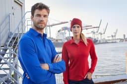 A blue long-sleeve polo shirt worn by a man and a red one worn by a woman, both featuring a logo.