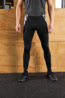 Men's black sports tights with a patterned panel on the sides, displayed on a person standing upright.