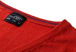 A red ladies v-neck vest made of knitted material, featuring a label and striped detailing around the neckline.