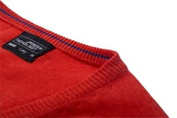 A red knitted jumper with a V-neck design and a label on the inside neckline.